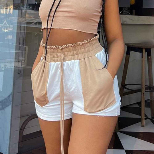 Two-tone beige and white drawstring shorts with elastic waist, ruffled trim