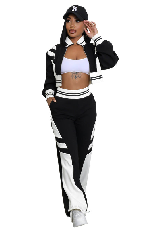 Black zip-up jacket and matching wide-leg pants with bold white stripe panels