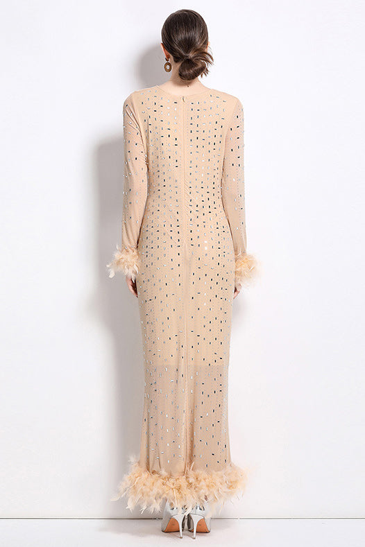 Beige maxi dress back view with dot pattern and feathered trim at sleeves and hem