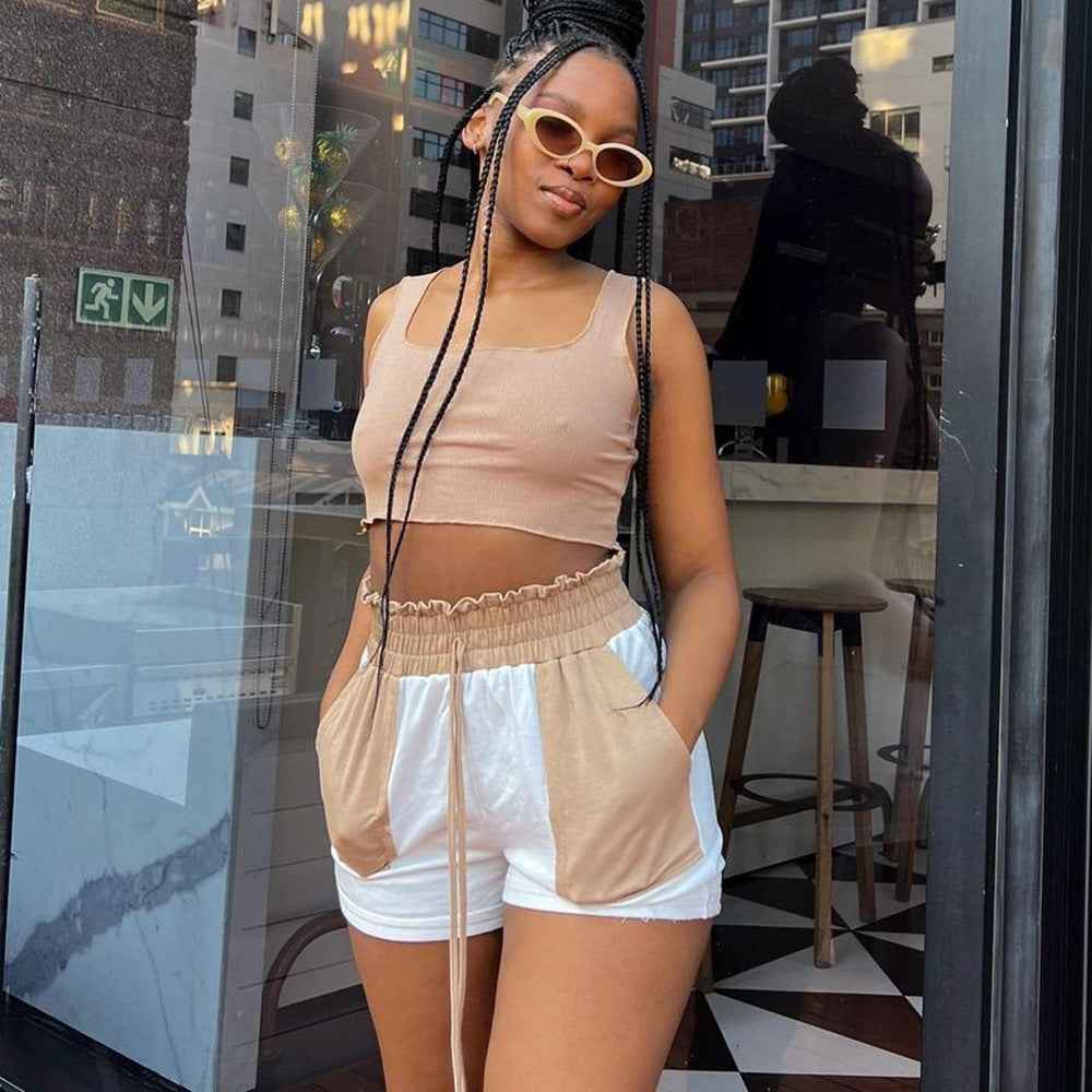 Beige and white color-block shorts with elastic waistband and drawstring ties