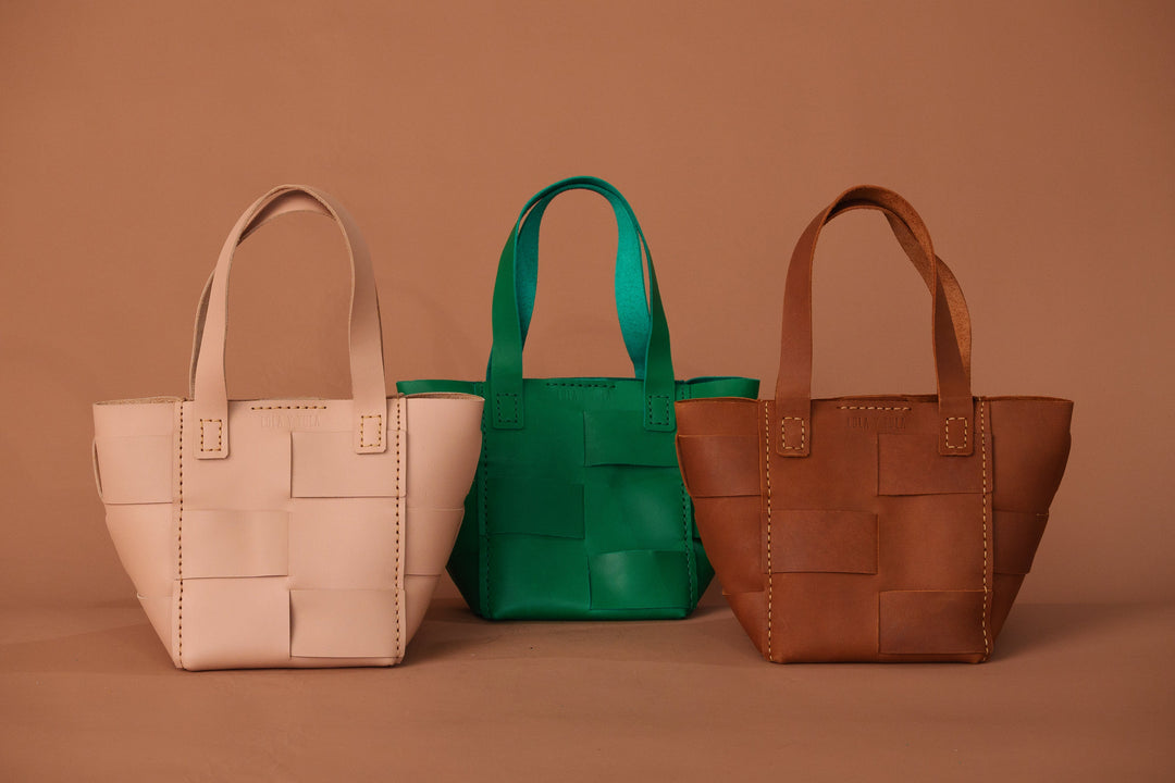 Basket totes in white, green, and camel brown; camel bag with front patch pocket