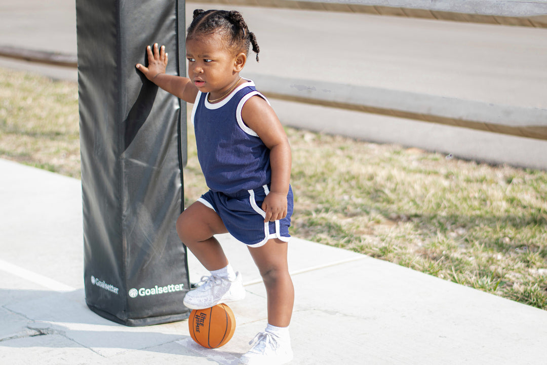 Navy sleeveless top and matching track shorts with white trim, toddler size