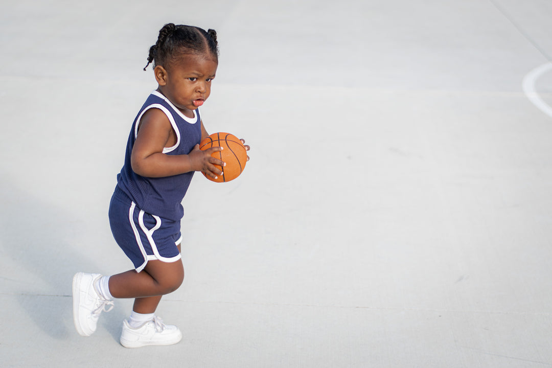 Navy toddler track shorts set with white trim: sleeveless top and striped shorts