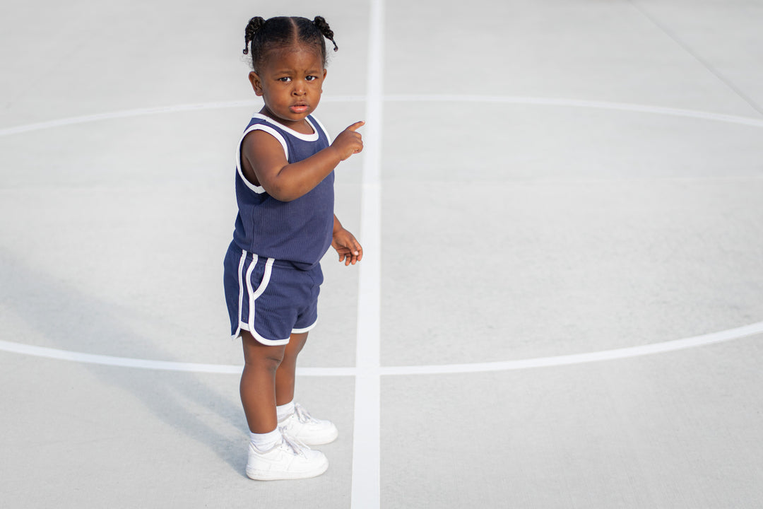 Navy toddler track shorts set with white neck trim and drawstring-style waistband