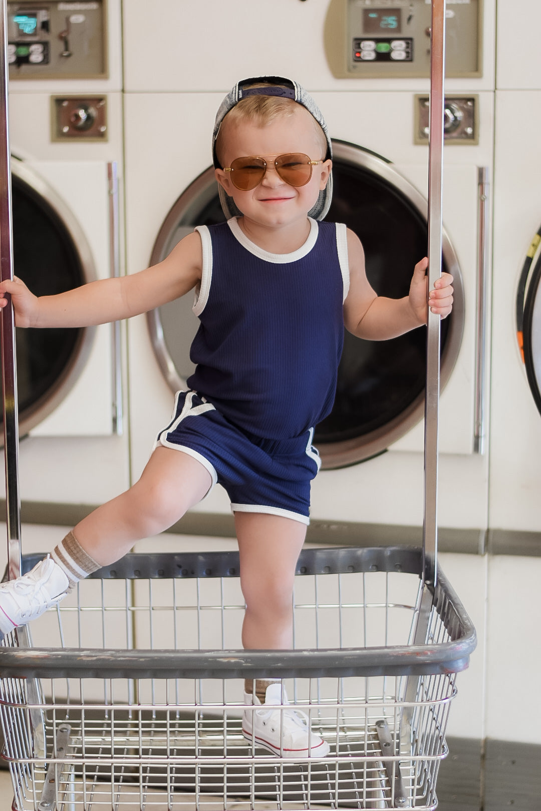 Navy sleeveless set with white-trim tank and shorts, toddler wearing mid-calf white sneakers