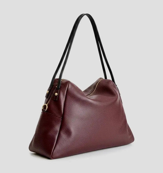 Burgundy slouchy tote with zip top, curved front, and dual top handles