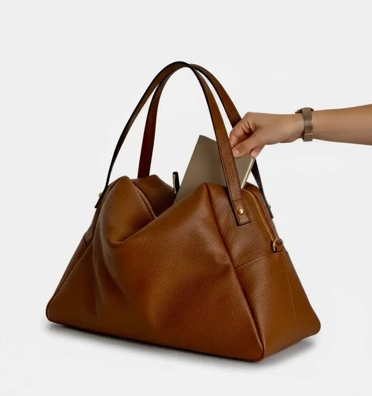 Camel slouchy tote bag with zip top, curved gusset sides, and top handles