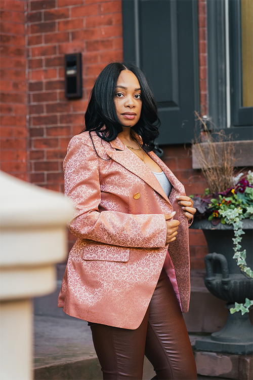 Blush blazer with ornate print, gold buttons, and relaxed open front
