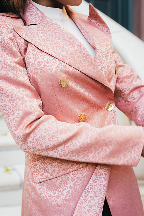 Blush blazer with ornate pattern, notch lapel, gold buttons, tailored fit