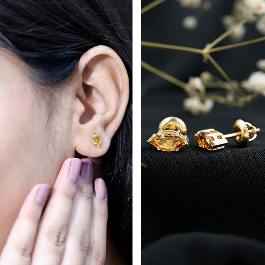 Citrine marquise stud earrings on ear, gold-tone setting and hoop backing