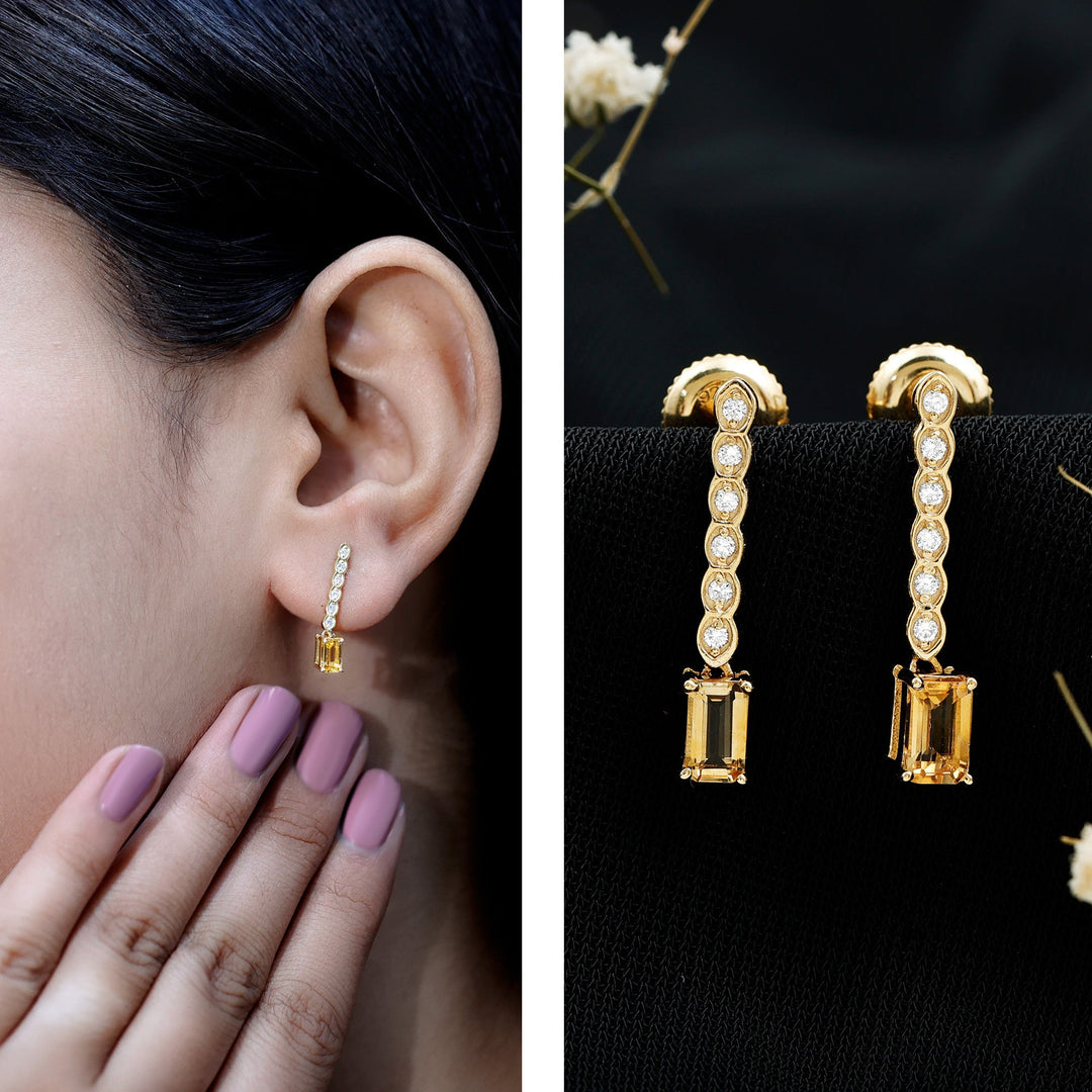 Gold-plated drop earrings with emerald-cut citrine and diamond bar on ear