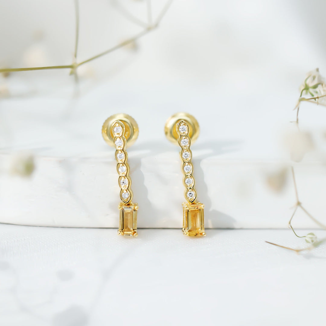 Close-up: gold-plated emerald-cut citrine bar drop earrings with round diamond accents