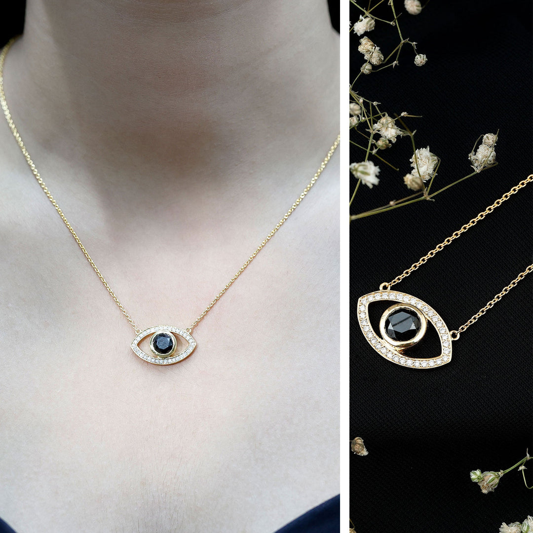 Evil eye necklace pendant with dark center stone and sparkling white pavé edge