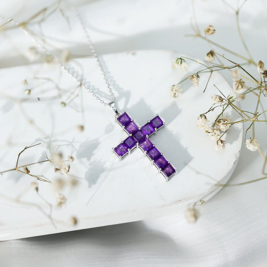 Purple amethyst cross pendant on silver chain with prong-set square gemstones