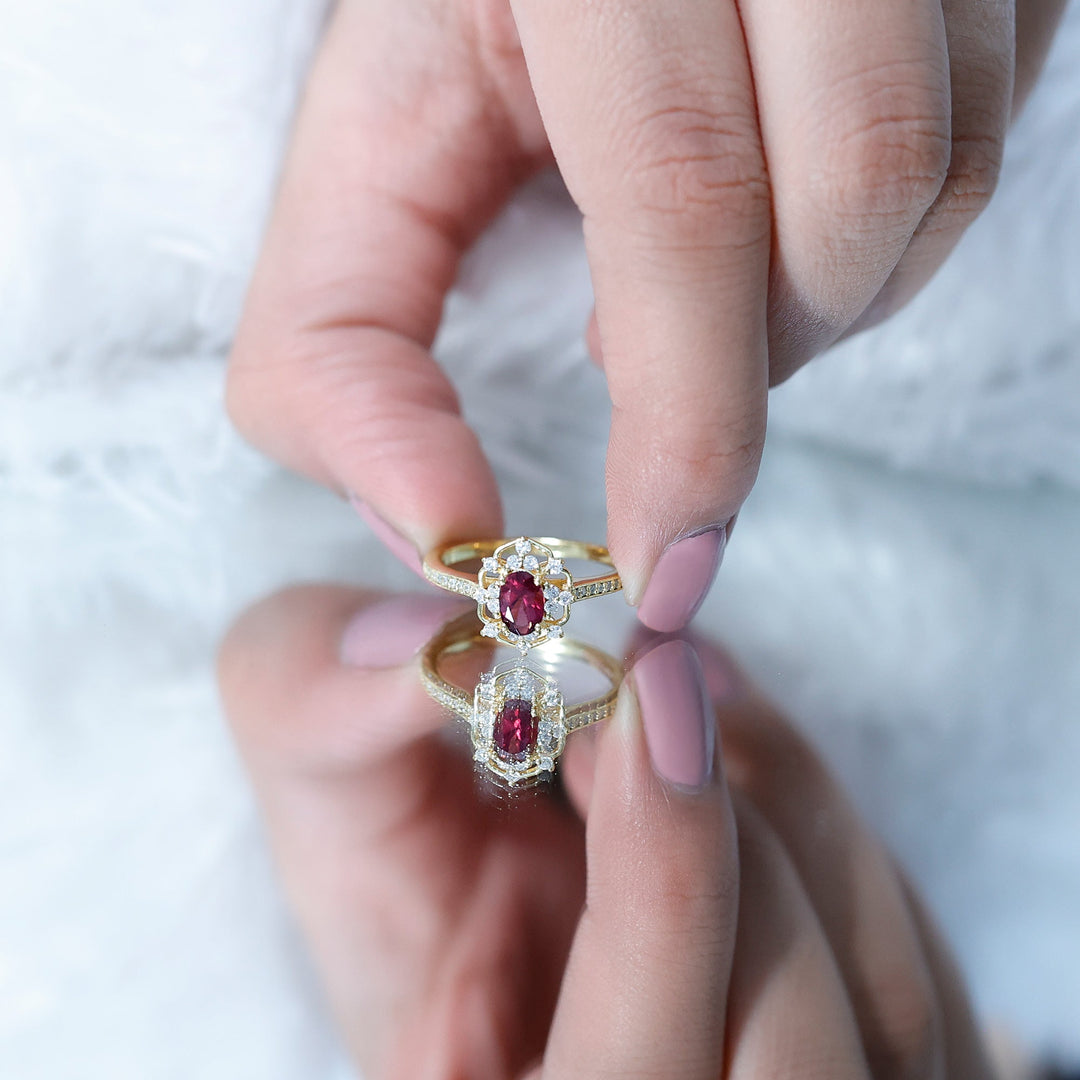 Rhodolite center ring with diamond halo and pavé band, worn on hand