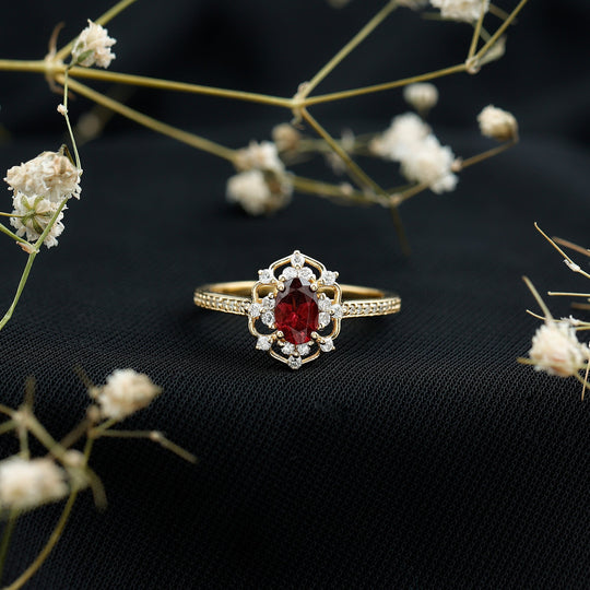 Oval rhodolite engagement ring, gold-toned band with diamond pavé and halos