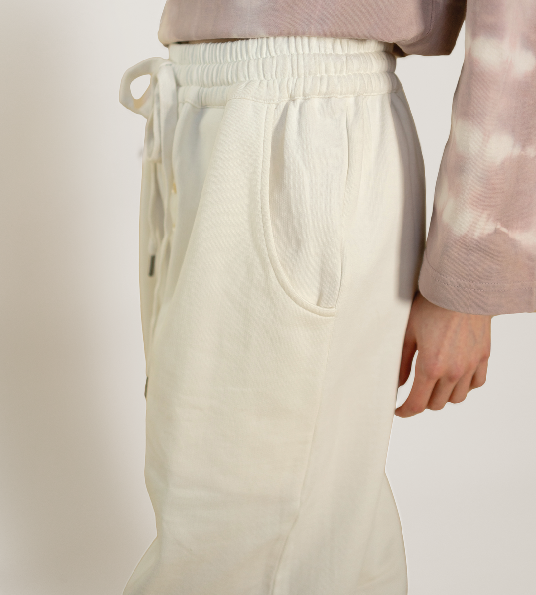 Off-white lounge pants with back patch pocket and ribbed elastic waistband
