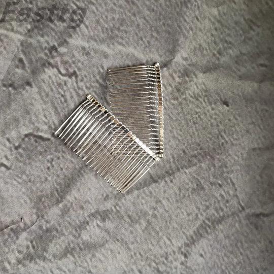 Silver-tone comb with rows of teeth to secure the bridal veil