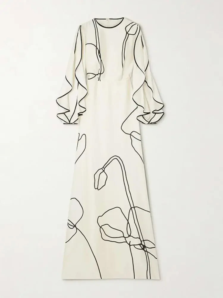 White evening dress flat lay with black floral line art, long sleeves