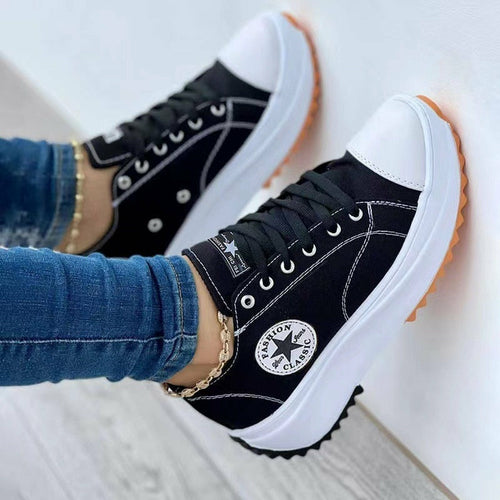 Black canvas sneakers, low profile with laces and gum-toned rubber sole