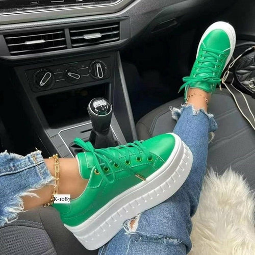 Green lace-up platform sneakers with white rubber sole and textured sidewall