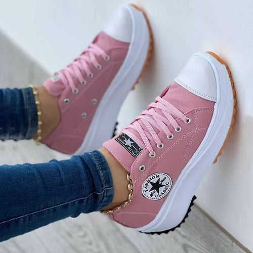 Pink canvas lace-up sneakers with side logo patch and white rubber sole