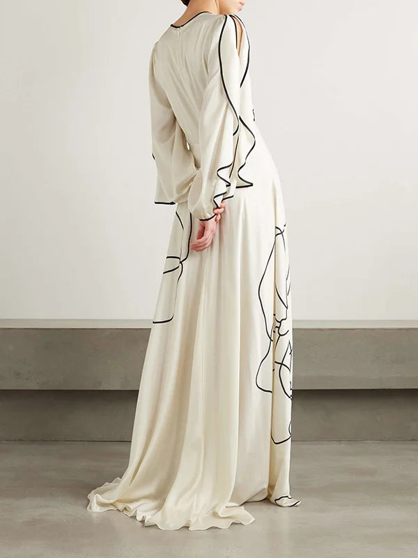 White maxi dress with black floral line print, draped sleeve detail, rear/side view