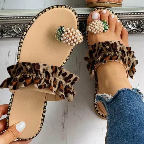 On-foot view: beige slides with pineapple pearl top and leopard-print ruffle straps