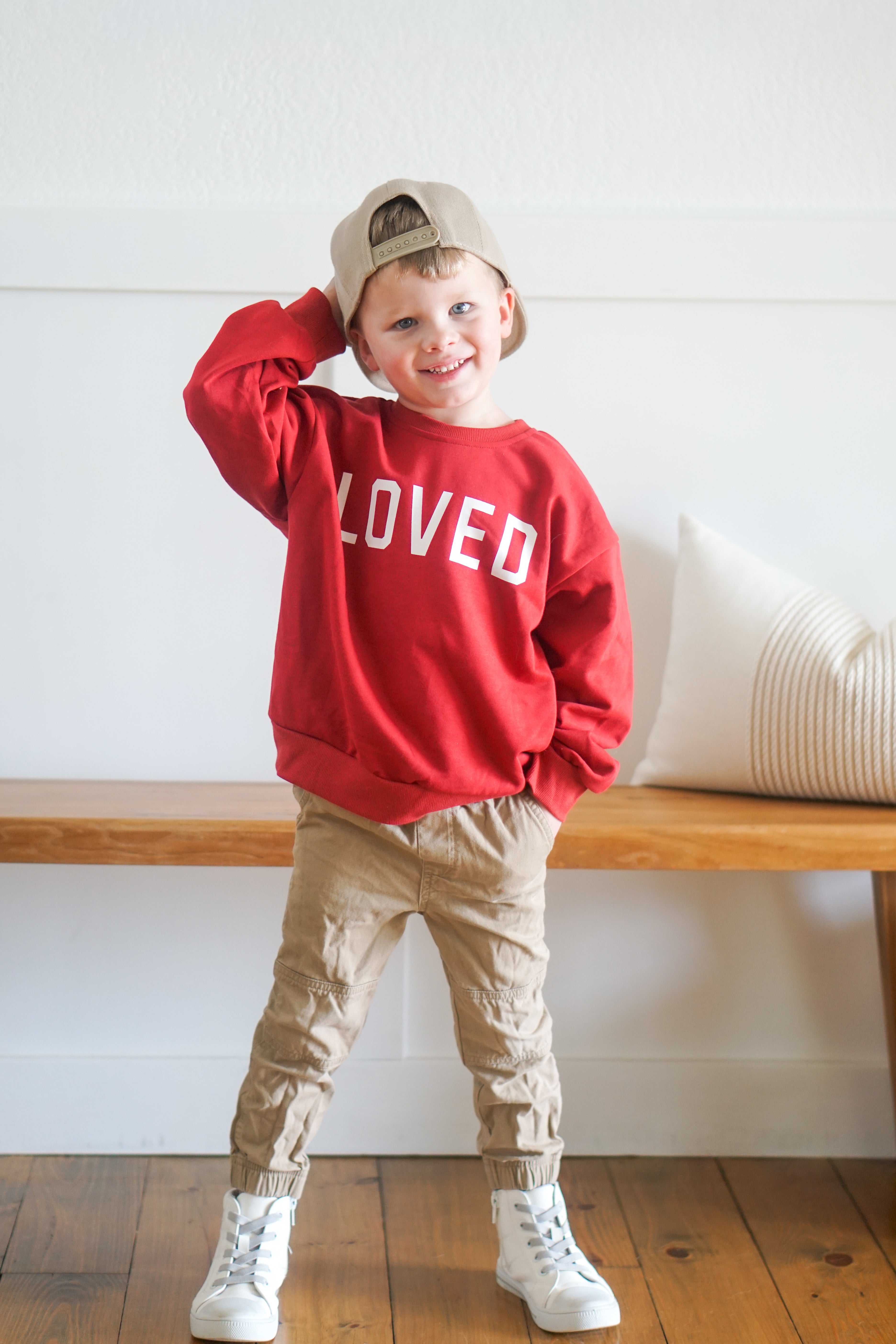 Red crewneck sweatshirt with 'LOVED' print, ribbed cuffs and hem.