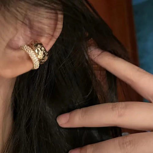 Gold tone geometric ear cuff earring with triangular cutout design