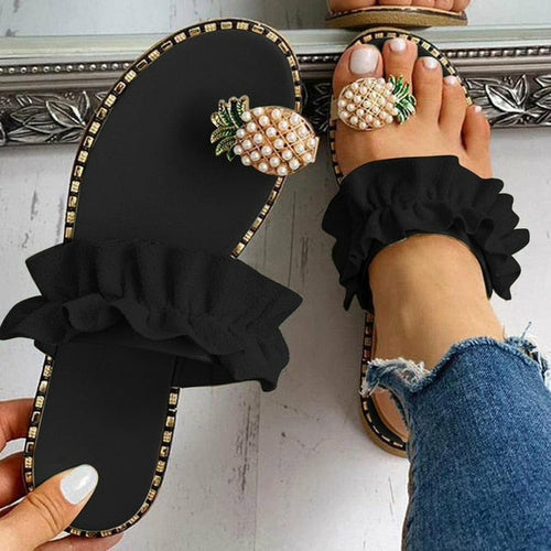 Flat toe beach slides, black upper with pearl pineapple ornament and ruffled strap detail