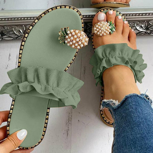 Light green flat toe slide with pineapple pearl ornament and green ruffle strap detail.