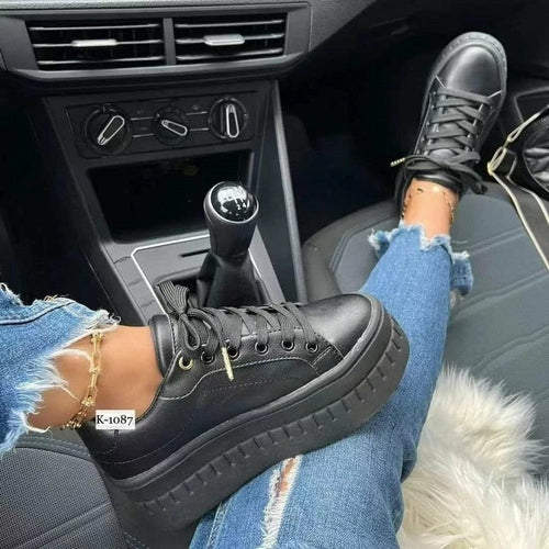 Black platform sneakers with lace-up front and white textured outsole