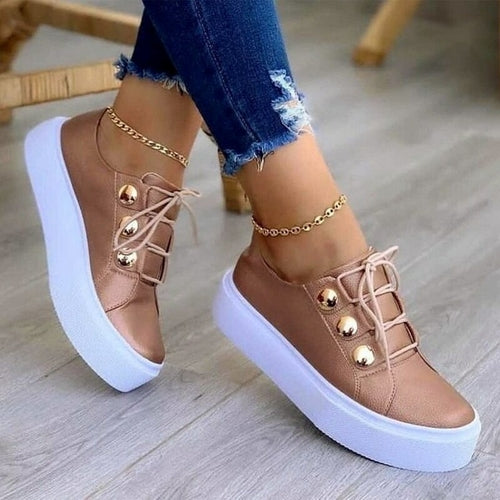 Rose gold women’s casual sneakers, lace-up style with gold eyelet details and platform