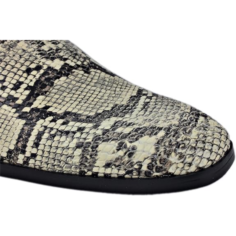 Close-up of beige snake-skin toe on chelsea boots with black trim