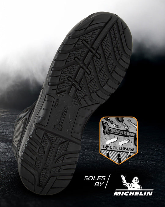 Black boot sole close-up with deep Michelin-style traction tread