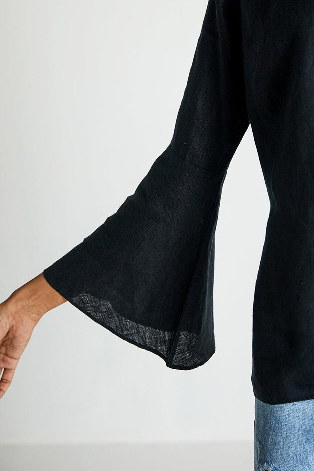 Black bell sleeve with rolled edge on The Button Back Shirt.