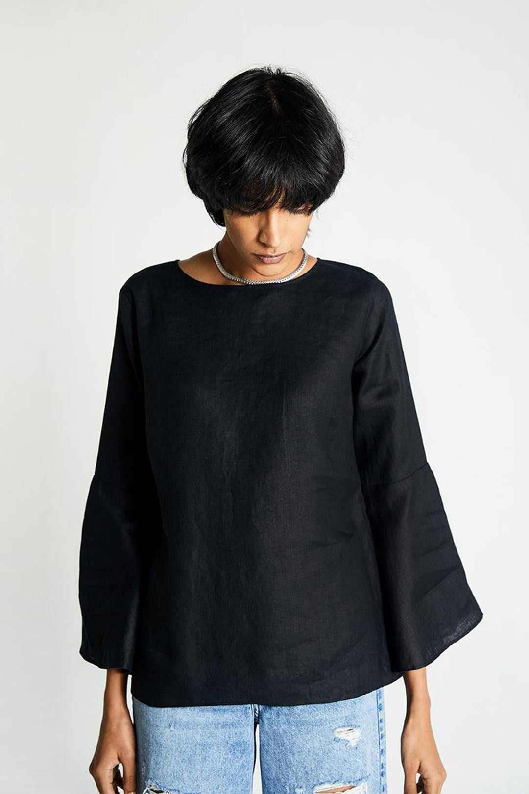 The Button Back Shirt in black with loose silhouette and wide sleeves.