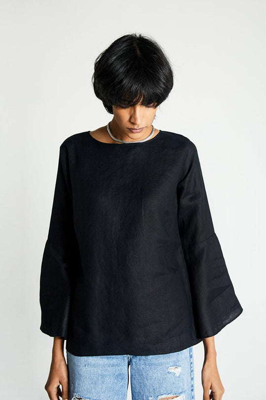 The Button Back Shirt in black with loose silhouette and wide sleeves.