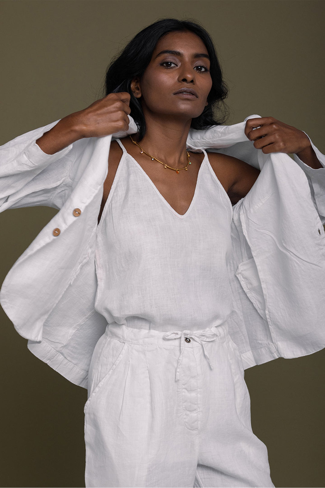 White three-piece set with unbuttoned jacket, V-neck camisole, and belted drawstring pants