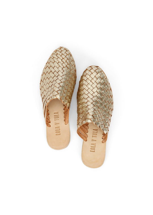 Gold woven leather slide sandals with rounded toe and visible insole branding
