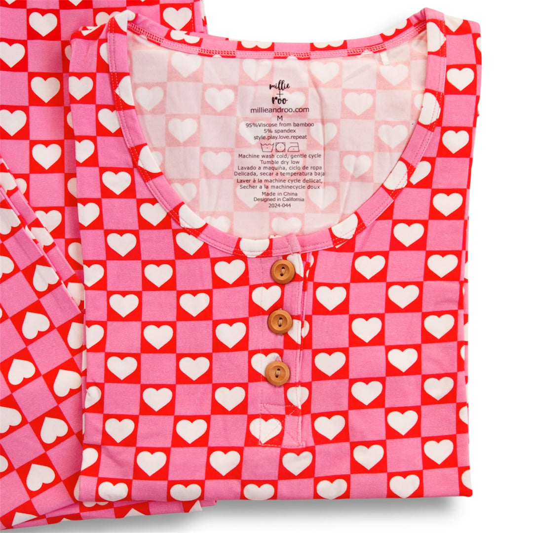 Red heart pajama top with button placket and tag; rounded crew neckline