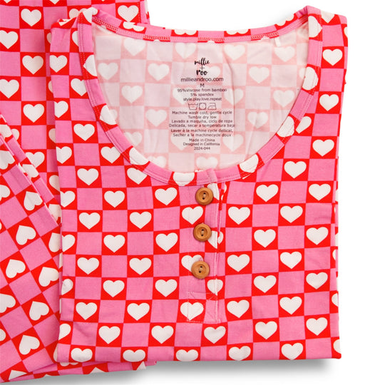 Red heart pajama top with button placket and tag; rounded crew neckline