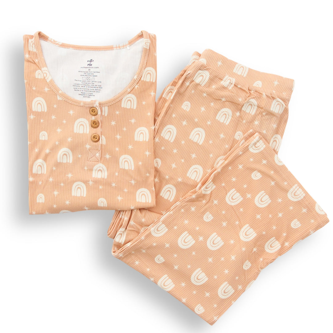 Peach rainbow ribbed pajama set laid flat: button henley top and matching pants