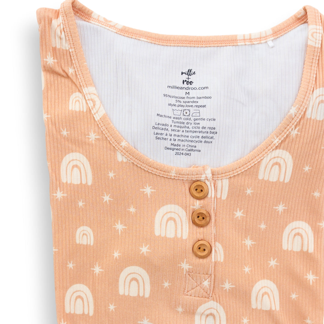 Peach ribbed henley top close-up with rainbow print and three wood buttons