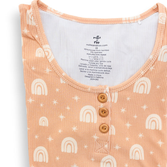 Peach ribbed henley top close-up with rainbow print and three wood buttons