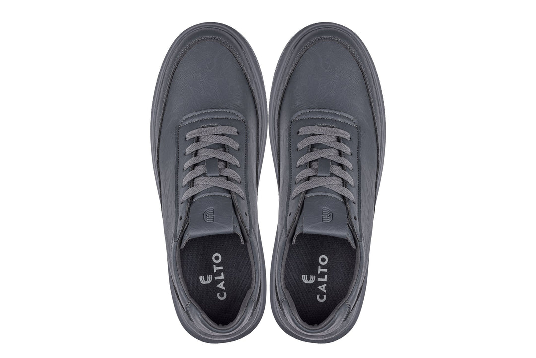 Pair of iron grey sneakers with gray laces and CALTO branding on inner tongue