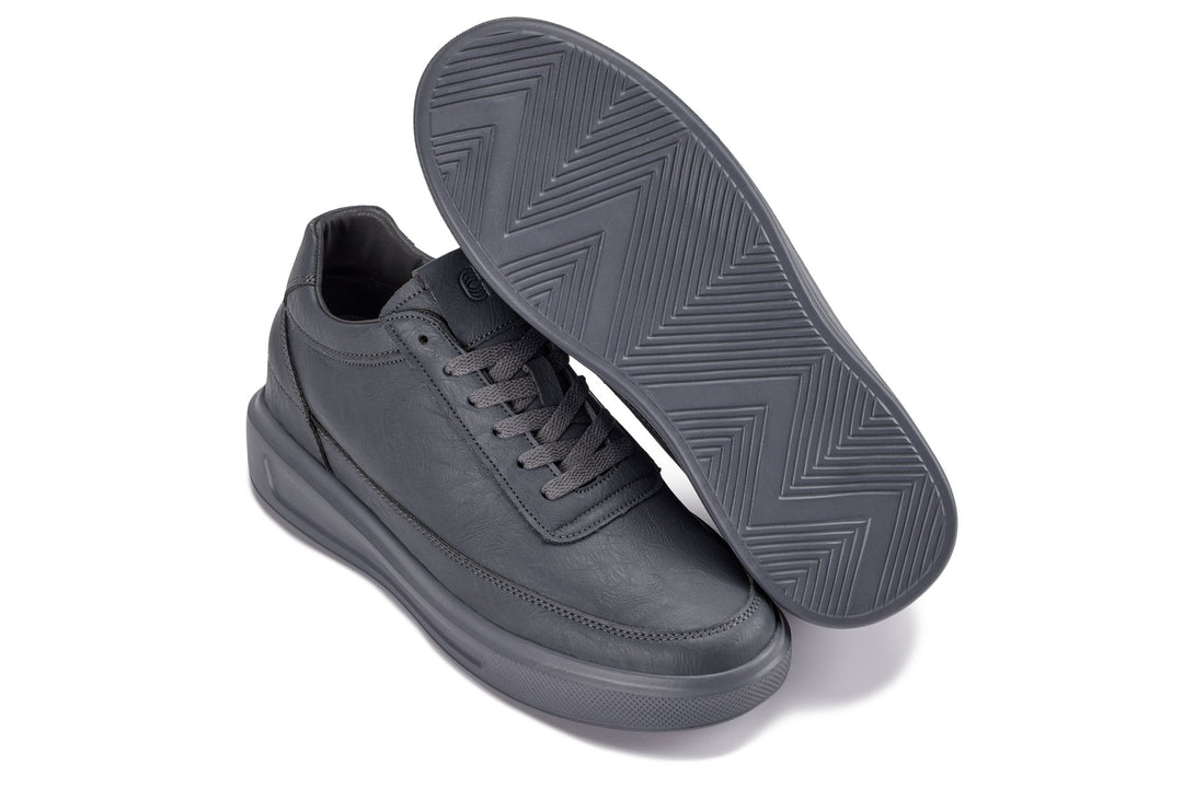 Iron grey sneakers with visible tread outsole and lace-up upper