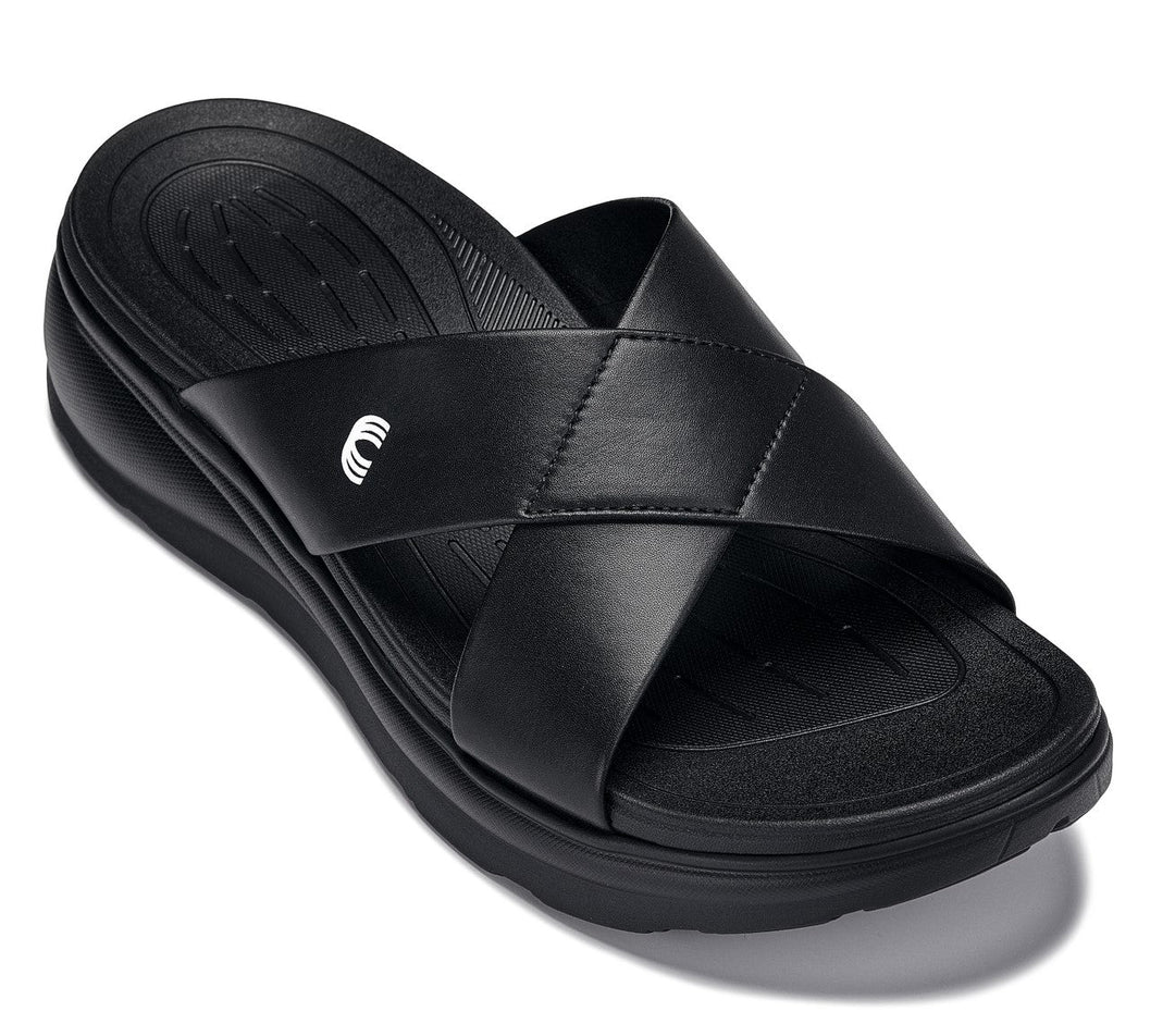 Black matte slide sandals with cushioned footbed, double-cross straps, and platform sole.