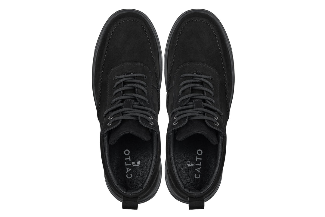 Black lace-up sneaker boots, front view with rounded moc toe and eyelet laces